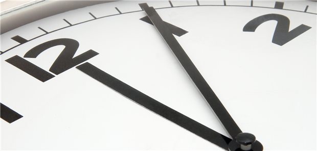 Eine Uhr steht auf fünf nach zwölf.