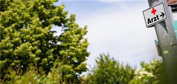 Schild mit der Aufschrift "Arzt" neben Baum