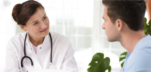 Patientengespräch zwischen einer Ärztin und einem jungen Patienten