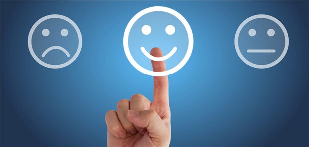Finger tippt auf einen gut gelaunten Smilie