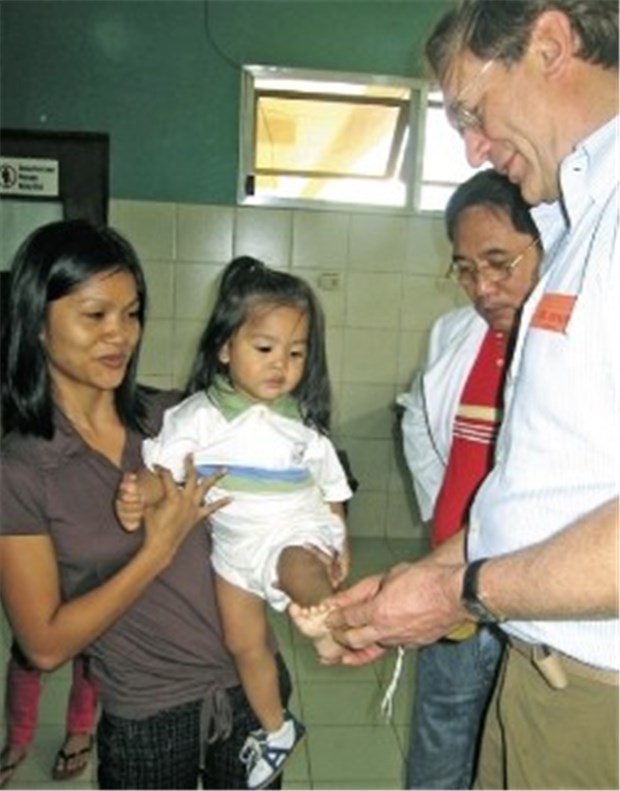 65 Kinder haben wieder eine Perspektive Dr. Klaus Exner untersucht eine junge Patientin auf den Philippinen.