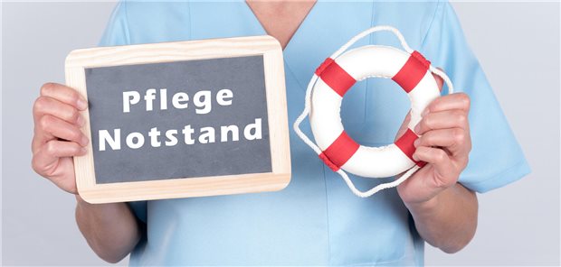 Schild mit Aufschrift "Pflegenotstand".