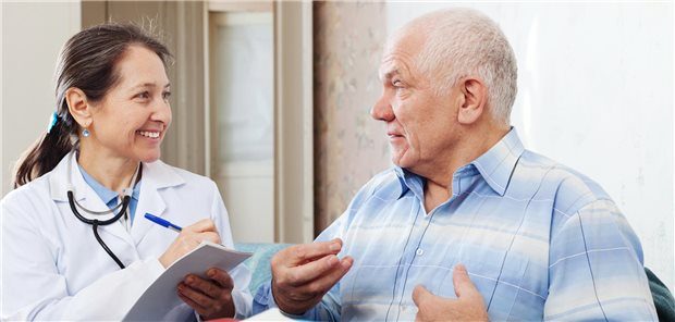 Eine Ärztin führt ein Patientengespräch mit einem beleibten Mann.