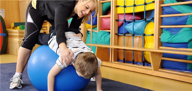 Blankoverordnung: GKV-SV fordert, Ergotherapeuten wirtschaftlich mehr auf die Finger zu schauen Kind macht mit einer Therapeutin Physiotherapie