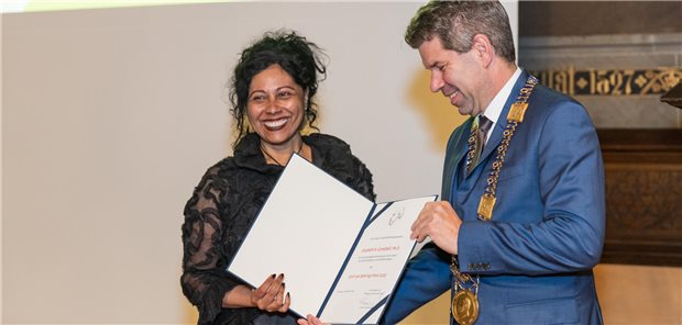 Behring-Preis an Corona-Forscherin verliehen Elizabeth Campbell erhält die Urkunde zum Emil von Behring-Preis 2023 aus den Händen von Universitätspräsident Thomas Nauss.