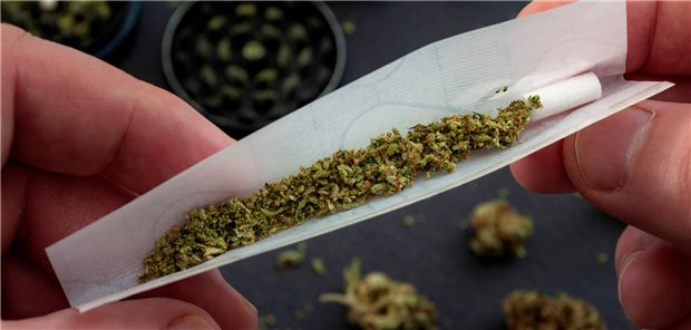 Wie verträgt sich Cannabiskonsum mit Operation und Narkose? In Nahaufnahme sind zwei Hände zu sehen, die einen Joint drehen.