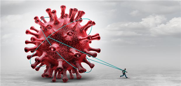 Ein Mann zieht an einem riesigen Virus. 