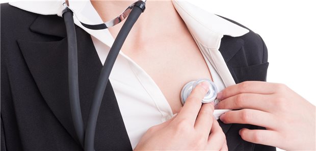 Eine Frau hört ihr eigenes Herz ab.