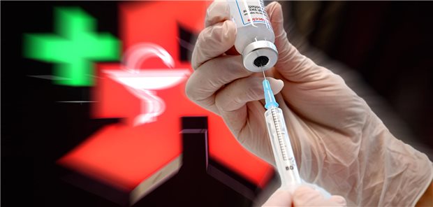 Eine Spritze wird vor einem Apothekenlogo aufgezogen.