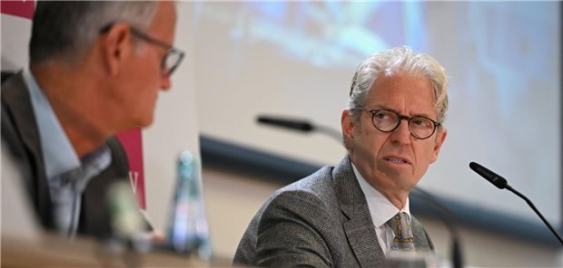 Zwei Männer Dr. Gaß von der Krankenhausgesellschaft und Dr. Gassen von der KBV auf einem Podium blicken sich an.