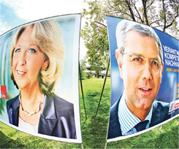 Alle sind sich einig: Mehr Geld für NRW-Ärzte Landesmutter gegen Bundesminister: Hannelore Kraft (SPD) und Norbert Röttgen (CDU) auf ihren Wahlplakaten.