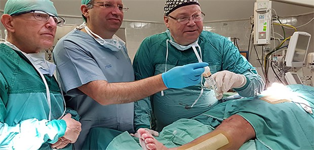 Im Labor gezüchteten Knochen implantiert Nimrod Rosen, Leiter der Abteilung für Orthopädie und Rehabilitation des HaEmek Krankenhauses im Norden Israels, (r), Schai Meretzki, Firmenchef von Bonus Biogroup (m), und Noam Bor Leiter der kinderärztlichen Orthopädie-Abteilung im HaEmek Krankenhaus (l), stehen vor dem Patienten, dessen Beinbruch mit injizierbarem Knochen behandelt wurde.