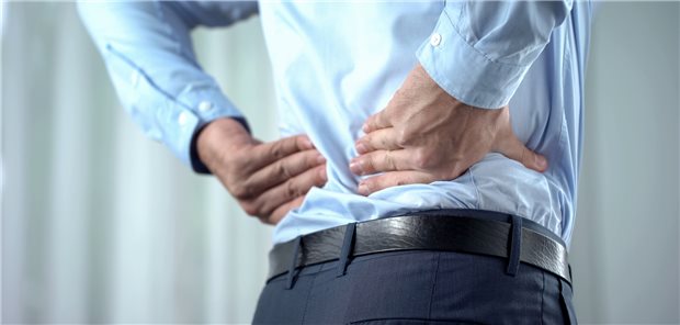 Office worker feeling sharp back pain, sedentary lifestyle, slipped disc