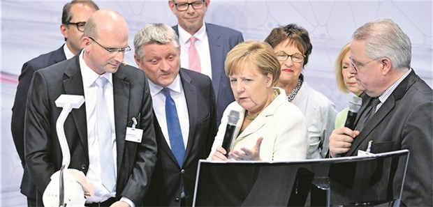 Digital Health braucht den dauerhaften digitalen Fiebermodus Professor Thomas Neumuth (l.) vom Leipziger Unimedizin-Innovationscenter erläutert Bundeskanzlerin Angela Merkel und Ressortministern beim Digital-Gipfel in Ludwigshafen am Dienstag das Modell einer computergestützten HNO-Op.