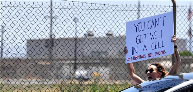 In US-Gefängnissen lauert der Tod Sorge um Gefangene: Ex-Häftling protestiert vor einem US-Gefängnis nach COVID-19-Ausbruch.