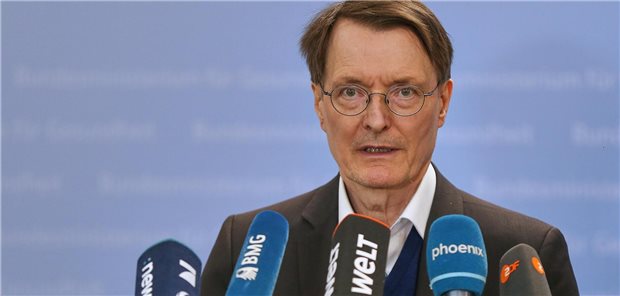 Karl Lauterbach steht vor Mikrofonen.