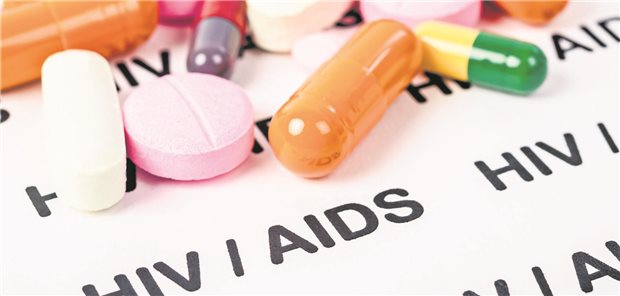 Tabletten auf einem Hintergrund, auf dem &quot;HIV / AIDS&quot; steht.