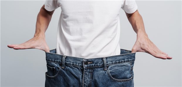 Mensch hält seine viel zu große Hose fest