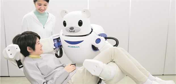 Auf der Suche nach digitalen Assistenzlösungen in der Pflege Vorbild Japan? Der Roboter ROBEAR kann Menschen aus dem Bett heben und auf einem Rollstuhl platzieren.
