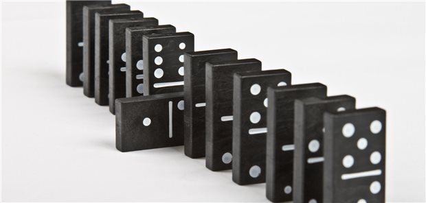 Domino-Steine in einer Reihe, wobei einer quer steht.